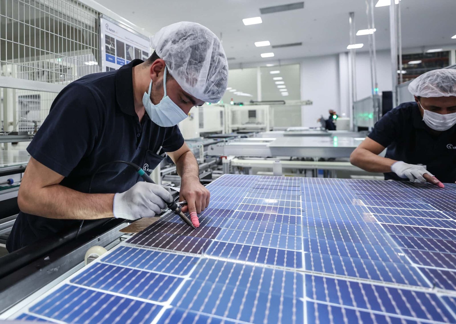 ANKARA, TURKIYE - MARCH 18: Turkish scientists work during the manufacturing of solar panels at the Kalyon Photovoltaic Solar Technologies Factory in Ankara, Turkiye on March 18, 2022. Approximately 30 million dollars of natural gas imports were prevented by connecting the solar panels produced in Ankara to the power plant located in Konya. Since 2019, more than 1.5 million panels have been produced at the Kalyon Photovoltaic Solar Technologies Factory, Turkiye's only and the world's leading integrated solar panel manufacturer, which was established on an area of ââapproximately 100 thousand square meters in Ankara's Baskent Organized Industrial Zone; while the rate of locality during the production steps of solar panels known as ingot, wafer, cell and module is at the level of 75% in the facility. (Photo by Berke Bayur/Anadolu Agency via Getty Images)